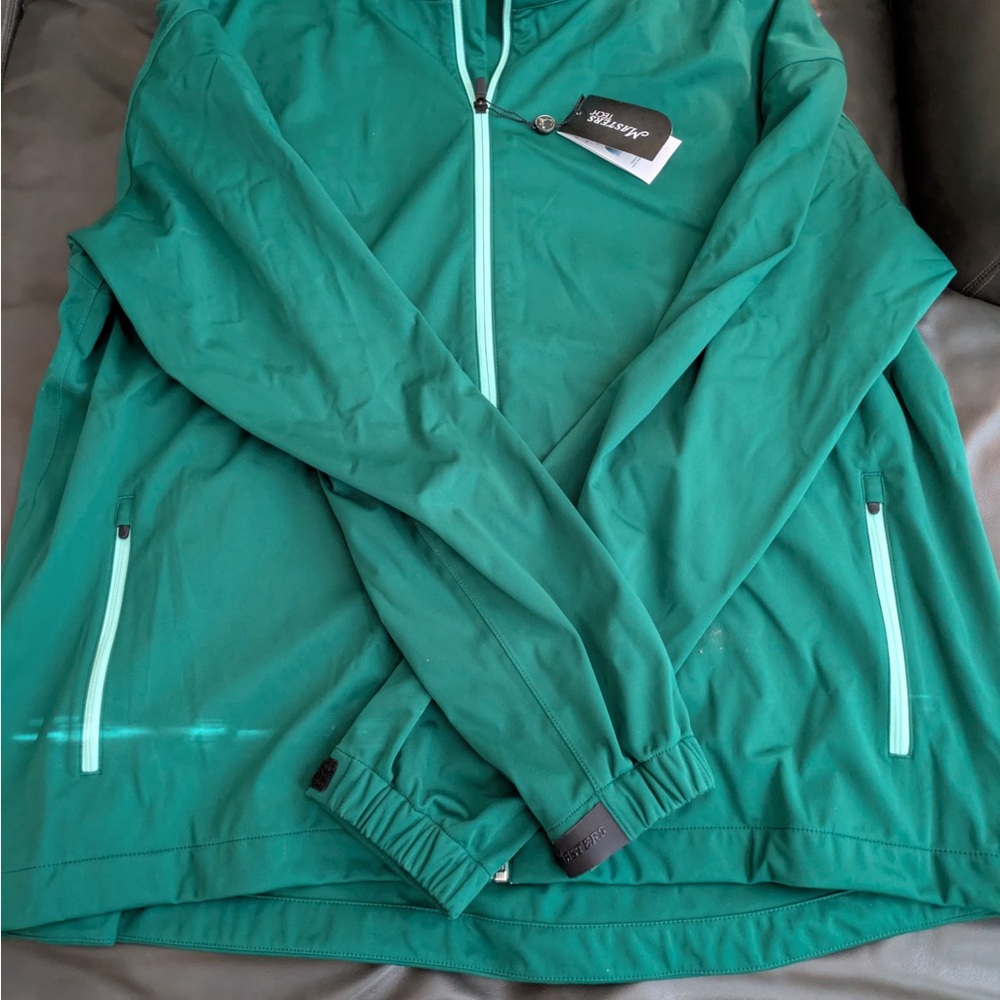 Official Masters rain jacket with hood in the collar. Size 3XL.